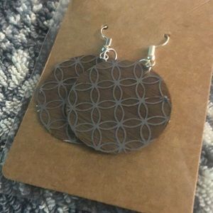 Homemade wooden earrings. Circle silver